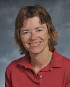 Portrait of a woman with short, light brown hair in a red polo.