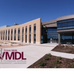 New TVMDL building with trees and plants in front with the maroon and grey TVMDL logo on the left bottom corner