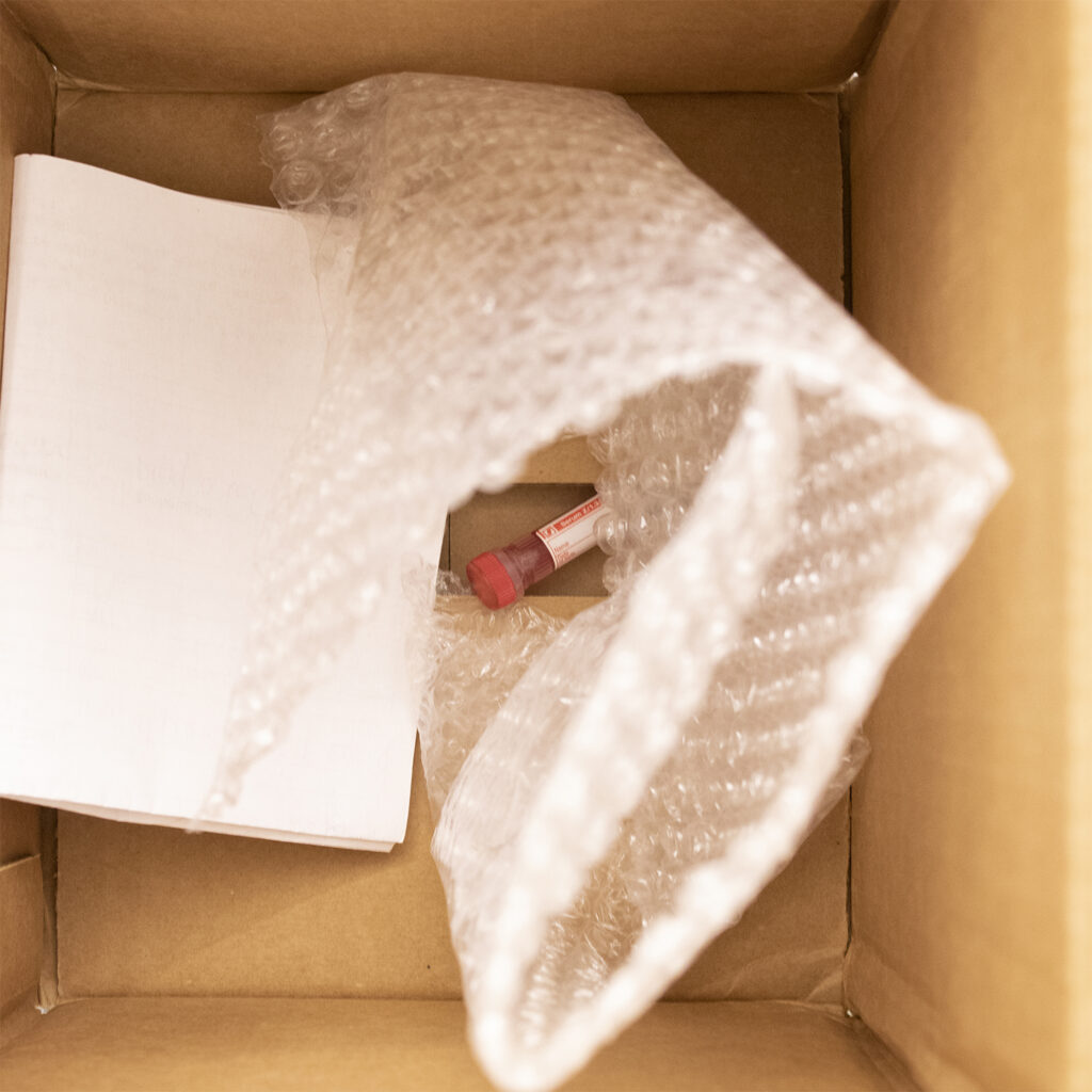 A small tube inside a giant box with one piece of bubble wrap