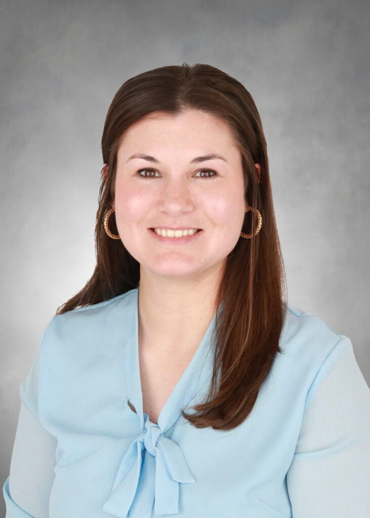 woman with brown hair and blue shirt posing for professional portrait